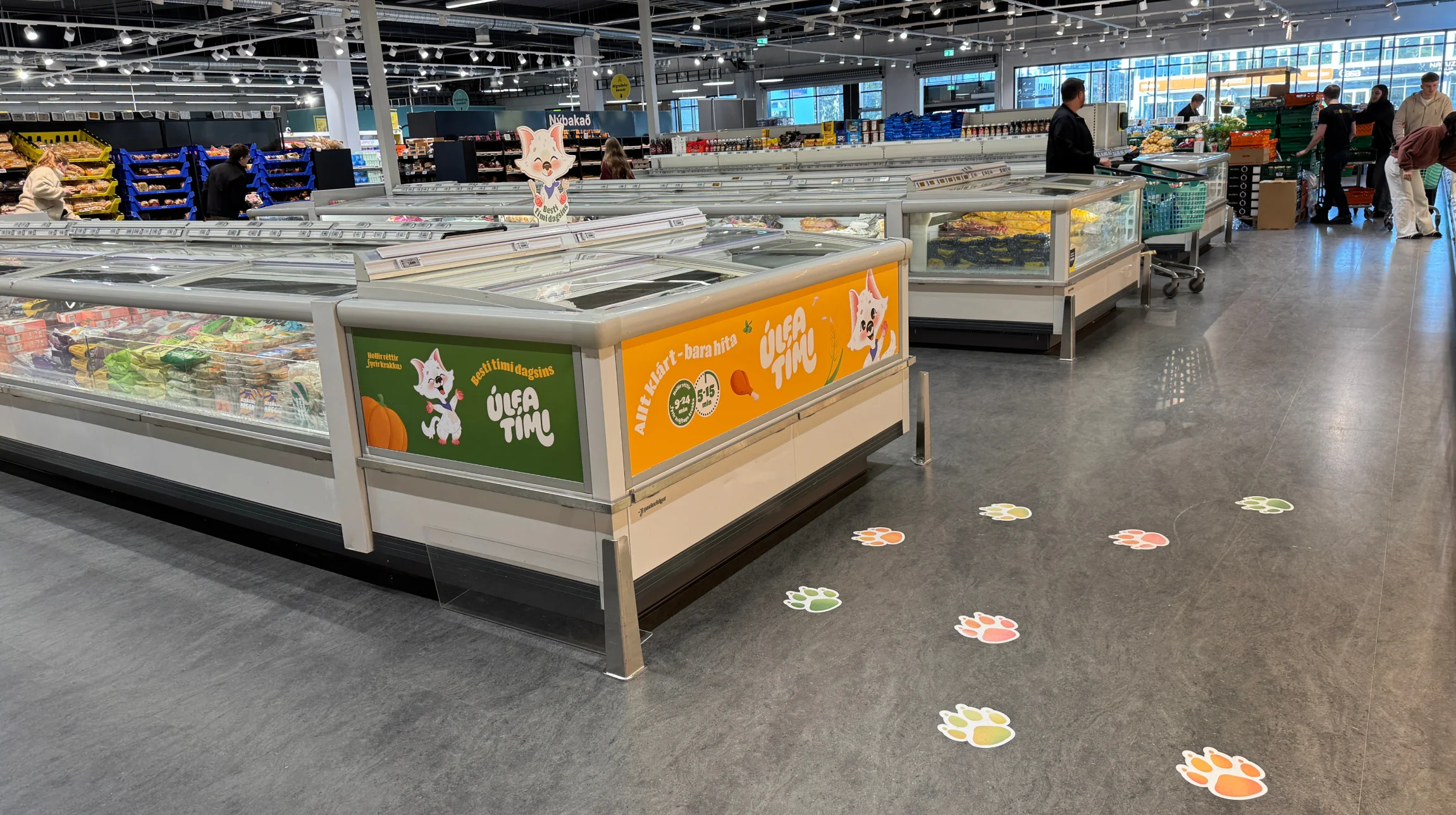 Branded freezer display with colourful paw prints leading through the shop